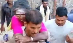 Cop wins hearts carrying woman devotee on his back on rocky terrain Cop wins hearts carrying woman devotee on his back on rocky terrain