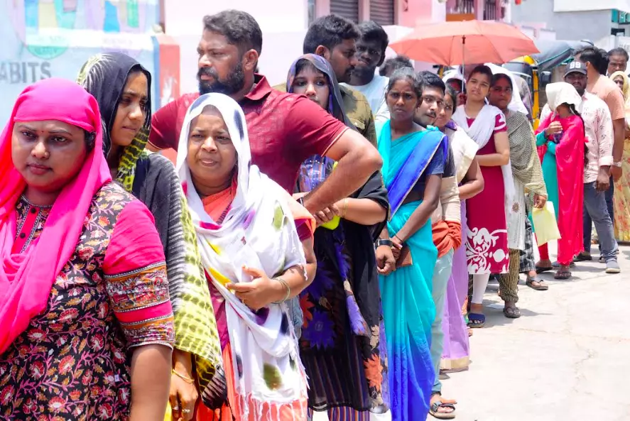 People wait in a queue under hot sun to cast their vote at a polling booth of Subbarao Nagar municipal school in Rajamahendravaram on Monday. - A.MANIKANTA KUMAR People wait in a queue under hot sun to cast their vote at a polling booth of Subbarao Nagar municipal school in Rajamahendravaram on Monday. - A.MANIKANTA KUMAR