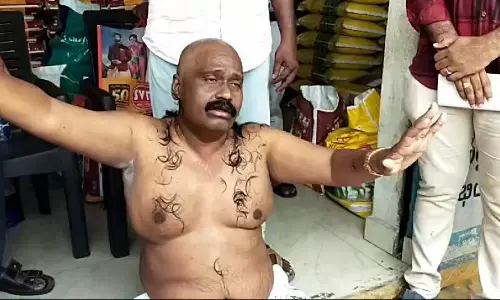 YSRC leader stages half naked protest for demolishing his building in Vijayawada