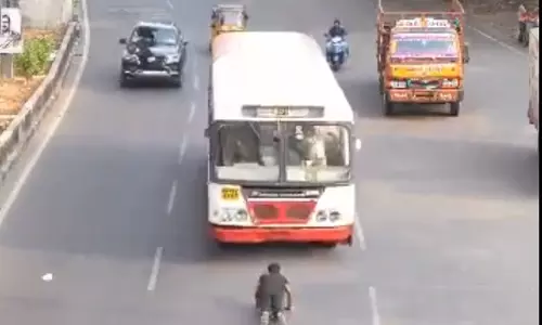 Fact Check: Viral video showing a man laying on the road even while an RTC bus is approaching him is fake