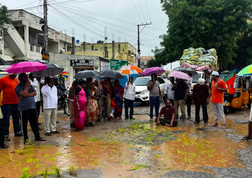 Telangana: BJP protests in Quthbullapur by planting rice saplings in potholes