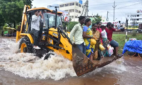 Residents take refuge on roofs as Budameru canal floods