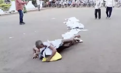 Madhya Pradesh: Man rolls on road with documents wrapped around neck to highlight demand, video goes viral