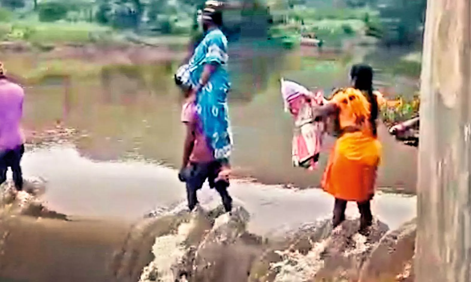 AP: Tribals brave swollen stream to carry mother, newborn across AP: Tribals brave swollen stream to carry mother, newborn across