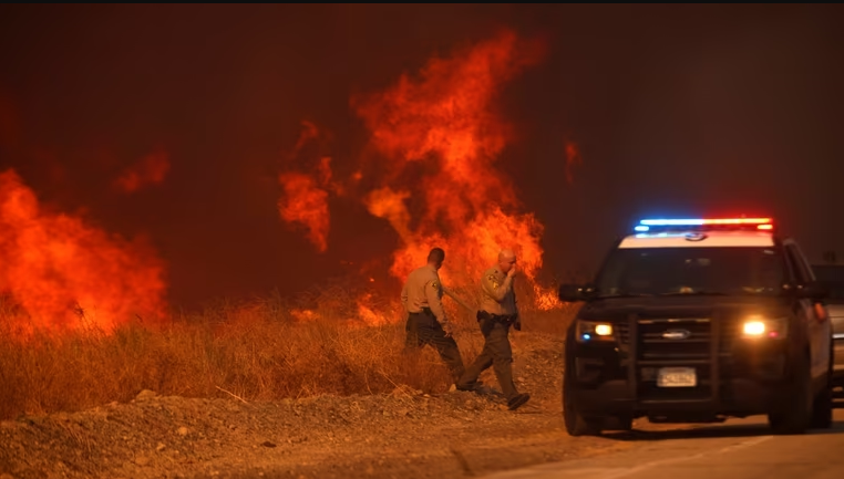 Firefighters struggle to control massive fire north of Los Angeles