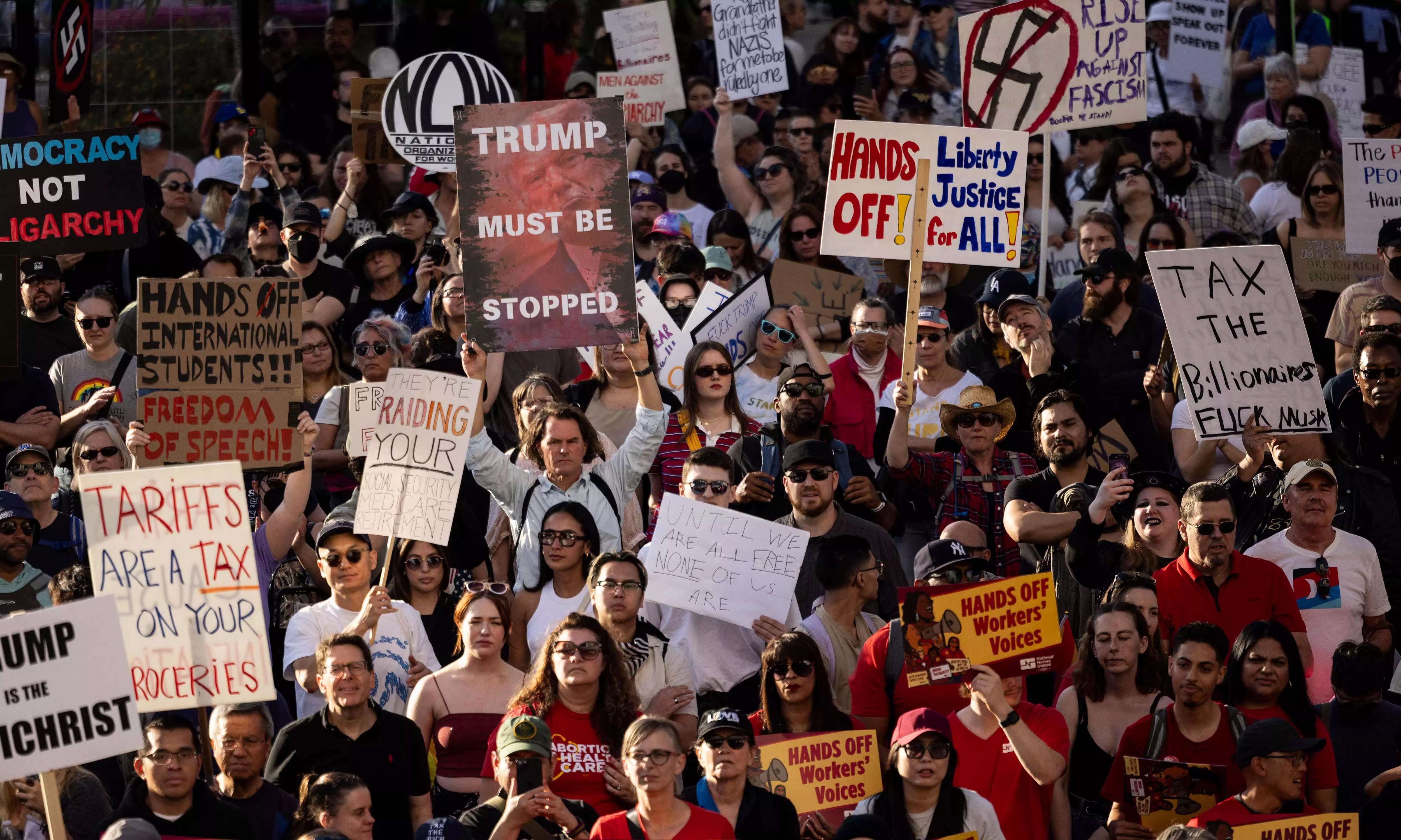 Protesters tee off against Trump, Musk in Hands Off! rallies across US Protesters tee off against Trump, Musk in Hands Off! rallies across US