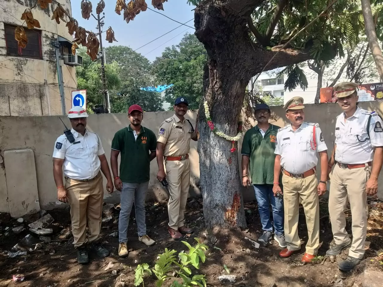 Traffic police stand in front of a ‘konda chinta’ tree that was translocated from in front of the Mahbub College in Secunderabad Traffic police stand in front of a ‘konda chinta’ tree that was translocated from in front of the Mahbub College in Secunderabad