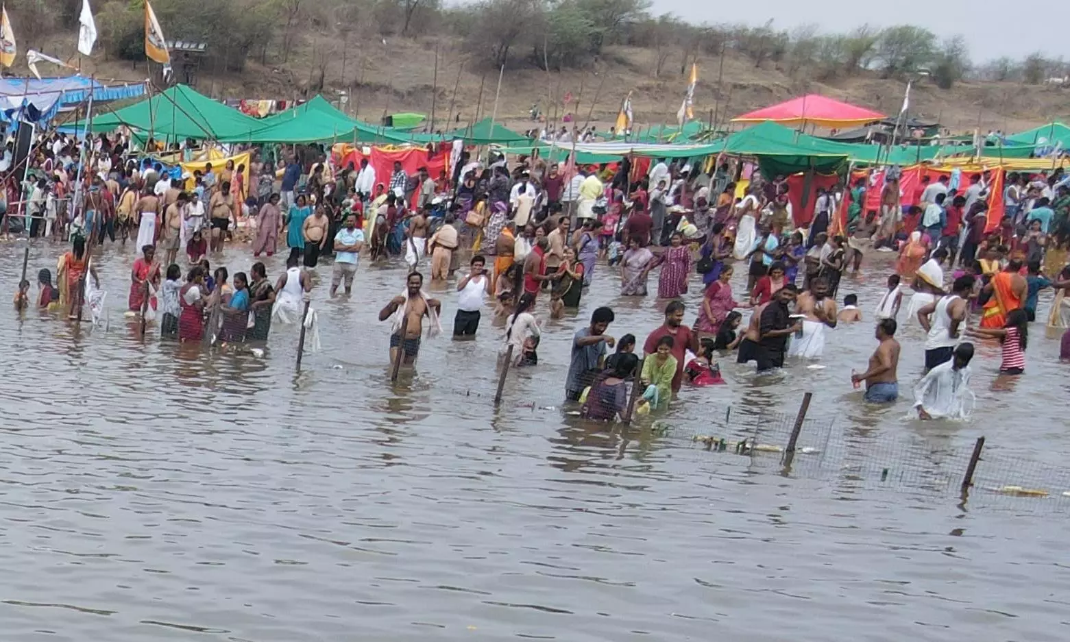 People Throng Pushkaralu Despite Heavy Rains