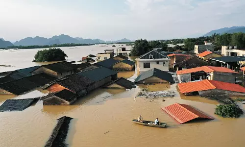 Flooding Destroys Dozens of Homes and Roads in China