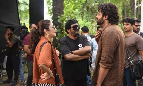 Prabhas Receives Surprise Visit from Puri Jagannadh and Charmee Kaur on The Raja Saab Set