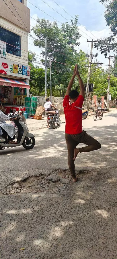 Man Protested For Pothole Repair By Doing Yoga Asana In It, GHMC Repairs It In Hours