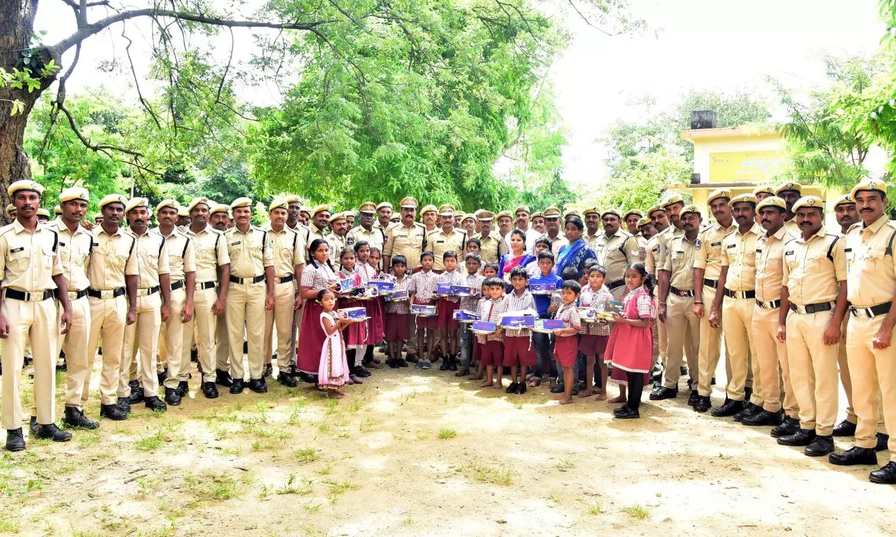 Students Receive Educational Material From Police