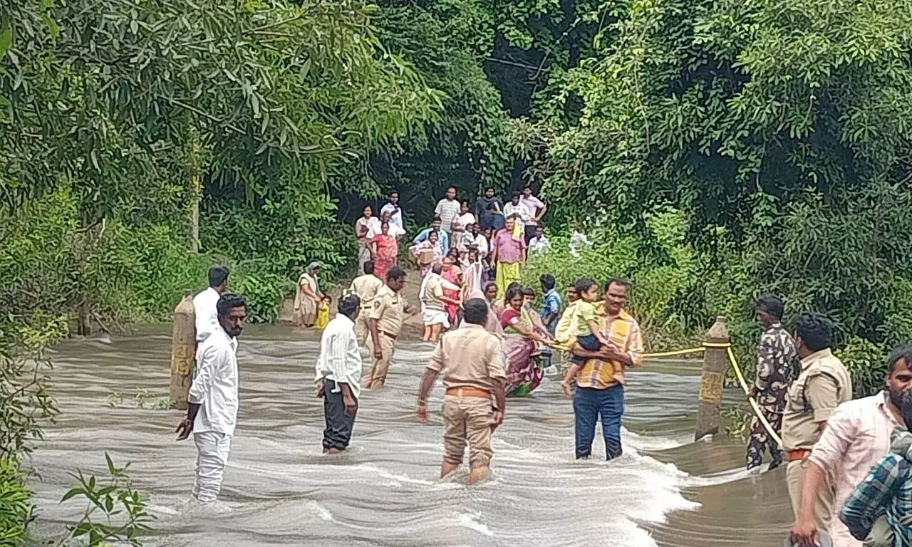 Devotees Rescued From Rising Gundlakamma at Nemaligundla Temple Devotees Rescued From Rising Gundlakamma at Nemaligundla Temple