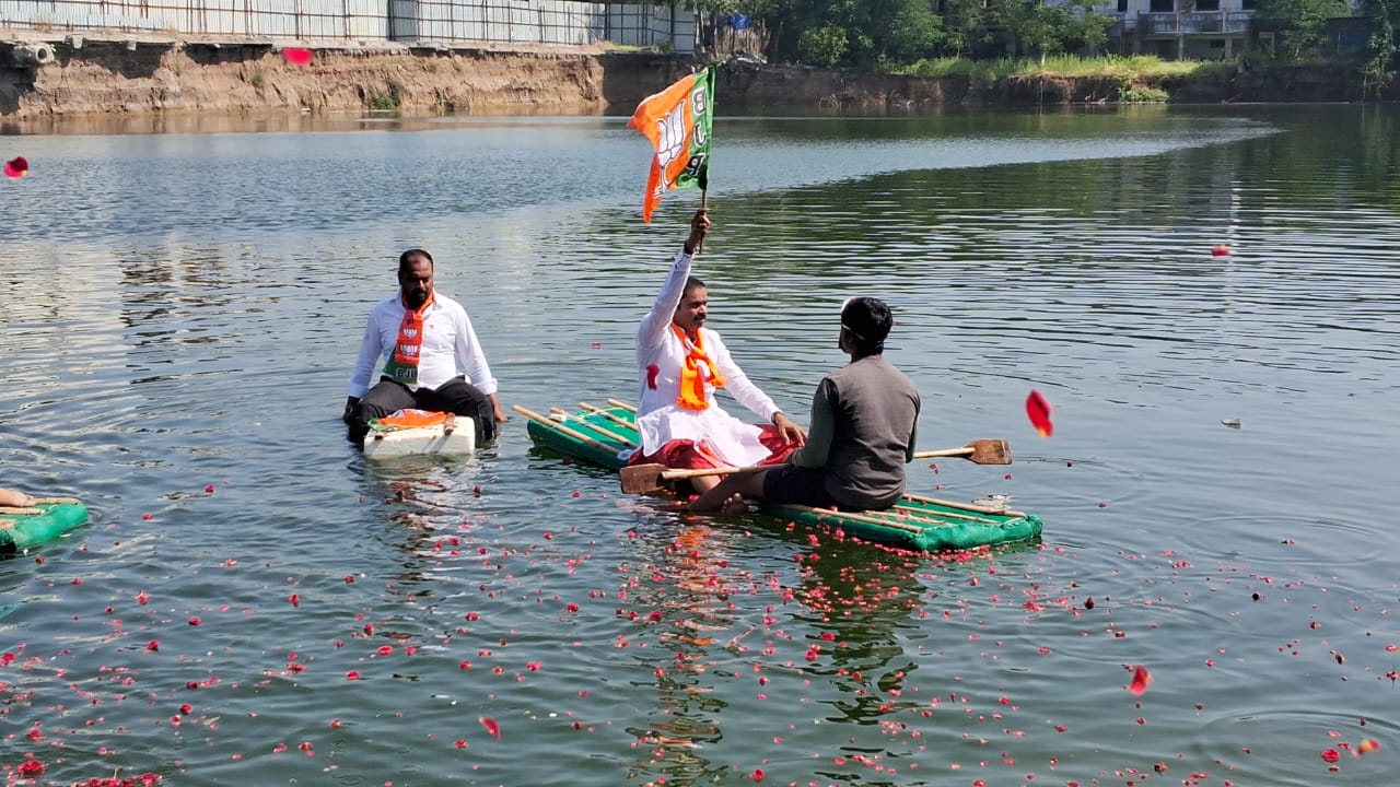 BJP Leaders Row Boats in Waterlogged Warangal Bus Stand Site to Protest Civic Mismanagement