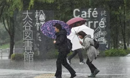 Heavy Rain Pounds Western Japan as Two Tropical Storms Approach