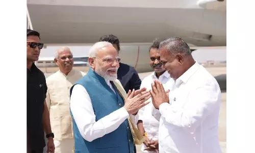 Modi Surprised by Minister Anand’s Pocket Portrait at Chennai Airport Reception Modi Surprised by Minister Anand’s Pocket Portrait at Chennai Airport Reception