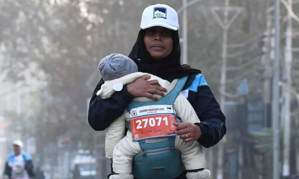 Woman Runs Kashmir Half-Marathon With One-Year-Old Son in Baby Carrier Woman Runs Kashmir Half-Marathon With One-Year-Old Son in Baby Carrier