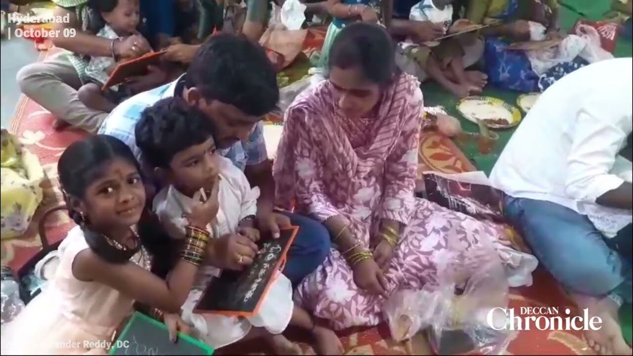 Parents performing ‘Aksharabhyasam’ to their children at Sri Gnana Saraswathi temple in Musheerabad